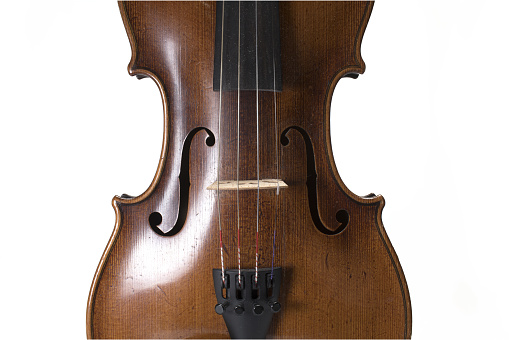Close up of sound body and strings of old violin with sound holes on white background