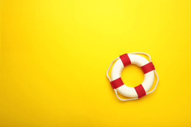 istock Lifebuoy on yellow background with copy space 1363973134