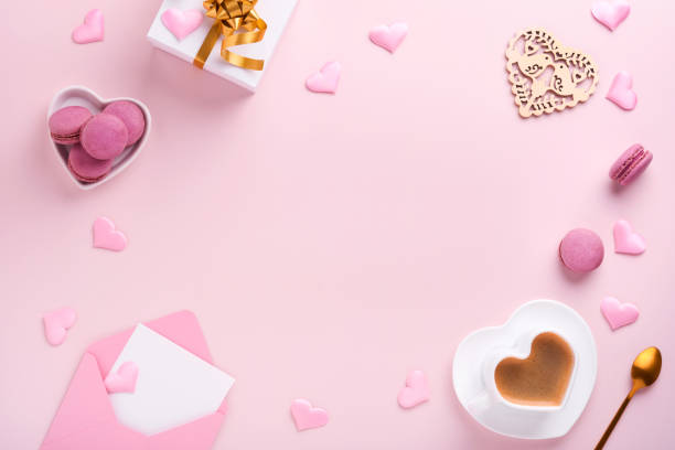 istock Valentines Day card. Pink empty envelope, macaron macaroon cookie and heart shaped coffee cup on pink background. 8 March, Womens Mothers Valentines Day, Birthday. Flat lay, top view, copy space. 1363973245