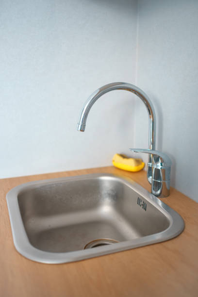 istock kitchen metal faucet above the sink. kitchen utensils 1363973383