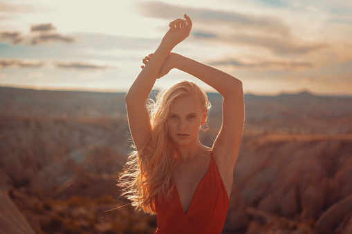 Portrait of young woman with blond hair in a red dress.