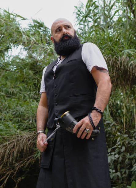 istock Viking skirt dressed modern man looking down in the woods 1363974303