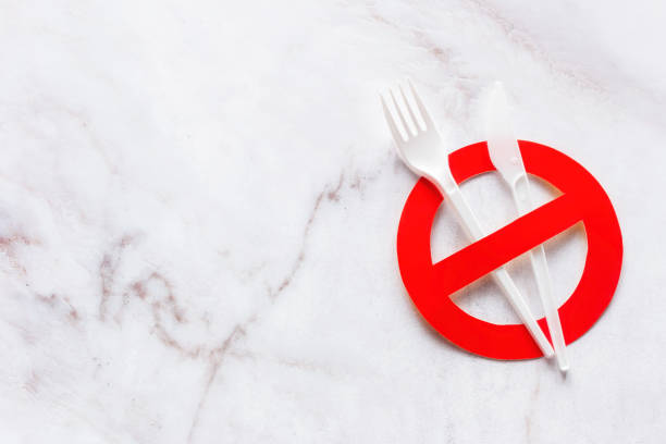 istock plastic cutlery and prohibition sign with place for text on marble background concept stop plastic 1363974454