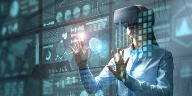 istock Young female engineer wearing vr headset touching HUD screen 1363976884