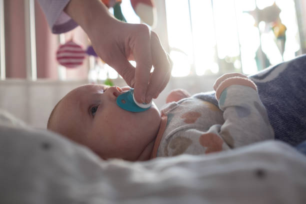 istock Mother giving her baby a pacifier to calm her down. 1363976893