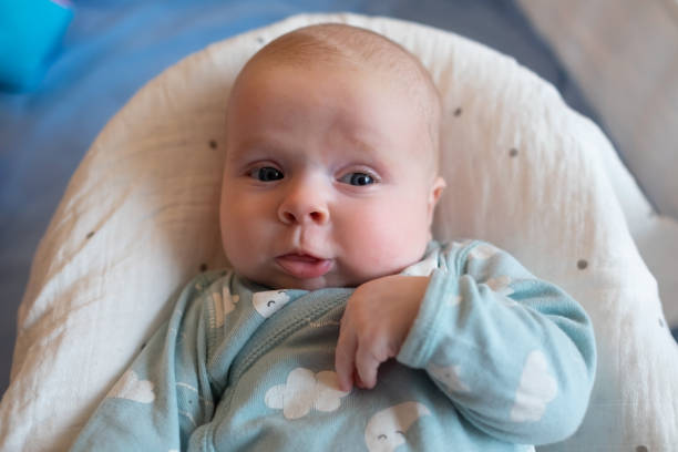 istock Baby girl looking at camera resting in bed 1363977713