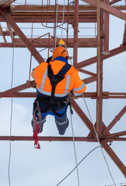 istock man working on high telecommunication tower. personal protection equipment, signal suit 1363977802