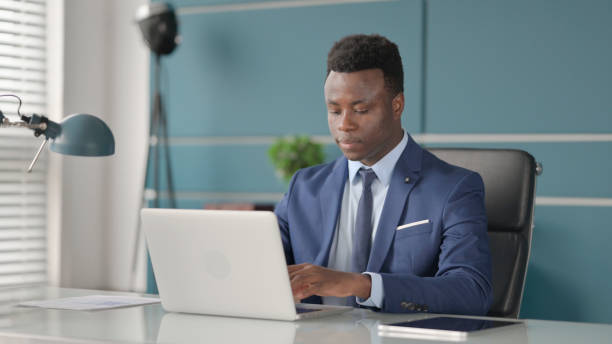 istock African Businessman Working on Laptop in Office 1363979567