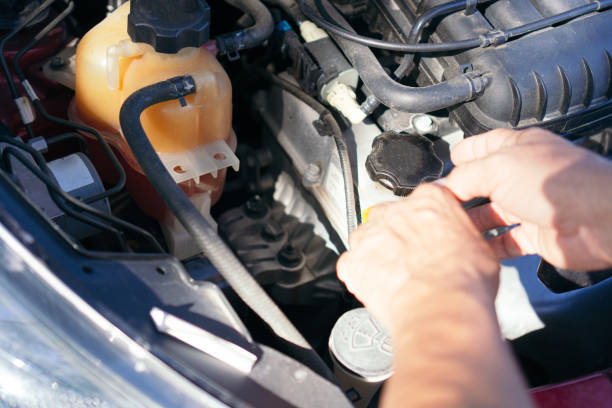 istock Man hands checking car engine. Guy checks his car 1363979675