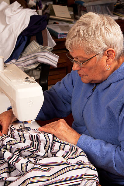 istock Senior woman sewing 136398045