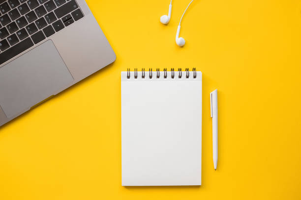 istock On a yellow background, a laptop, headphones, notepad and pen. 1363981248