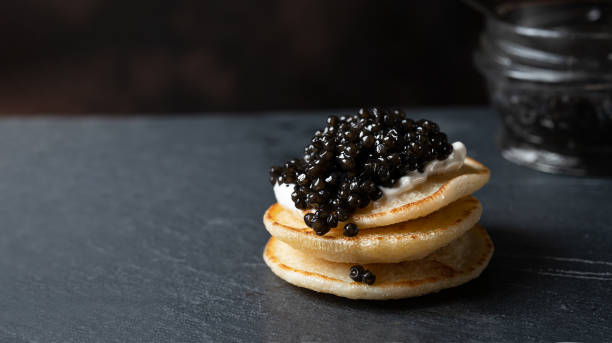 istock Small pancakes with black caviar 1363981942