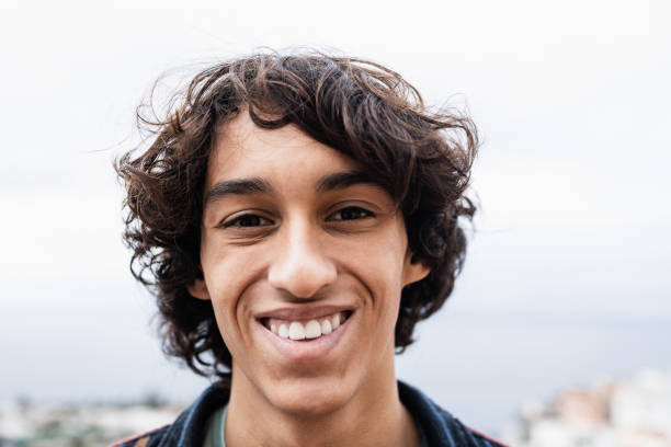 istock Young latin guy smiling on camera outdoor - Focus on face 1363982813