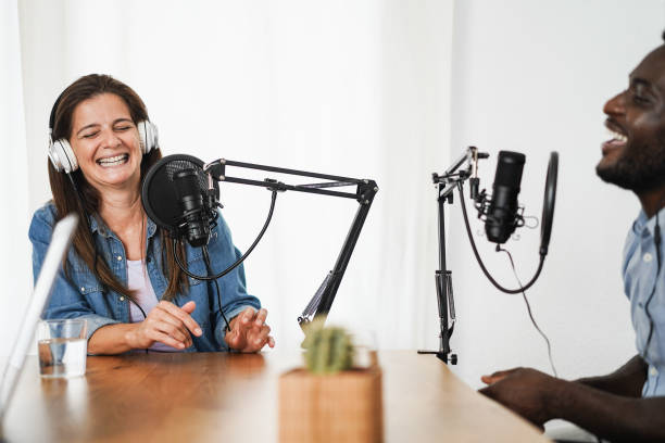 istock Multiracial hosts streaming podcast together at home studio - Focus on woman face 1363983424