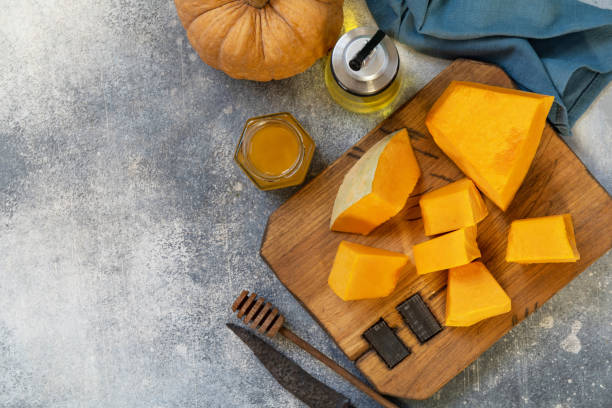 istock Raw pumpkin and honey for prepare baking over gray stone background. Top view flat lay. Copy space. 1363983723