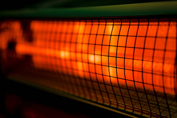 Close up of portable electric halogen heater on black background Close up of portable electric halogen heater on black background electric heater photos stock pictures, royalty-free photos & images
