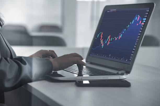 istock Business women analysing graph on laptop computer 1363984057