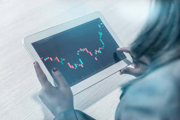 istock Business women touching graph on tab 1363984213