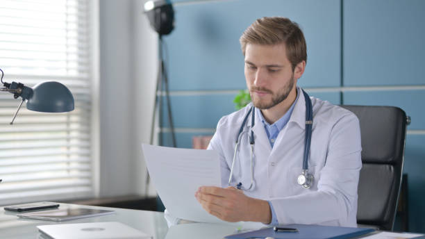 istock Doctor Writing on Paper in Clinic 1363985037
