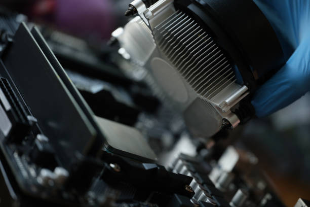 A hand in a glove installs a new cooler for a pc, close-up. Cooling system in the computer, repair, upgrade, cleaning from dust