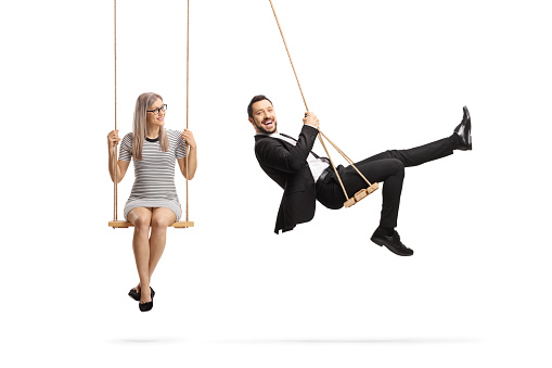 Businessman and a young woman sitting on swings isolated on white background