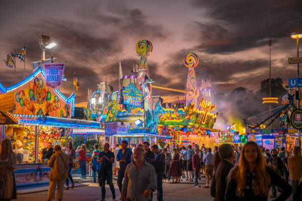 Munich, Germany - September 21, 2019: Visitors Walking Through Oktoberfest Fairgrounds, aerial view at dusk.