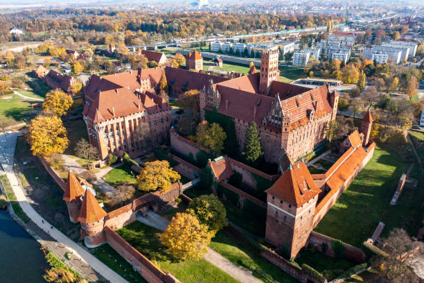 Malbork Castle (Marienburg, Zamek w Malborku) from above. Malbork - aerial view of The Castle of the Teutonic Order in a sunny autumn day. Blue sky on the background. marienburg stock pictures, royalty-free photos & images