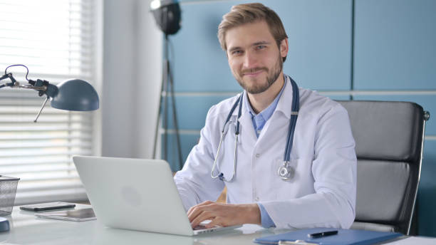 istock Doctor Shaking Head as No Sign while using Laptop 1363988434