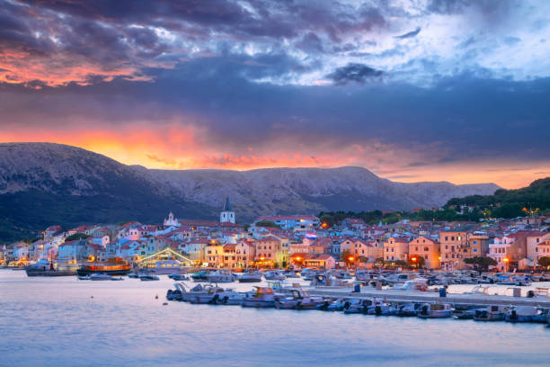 Cityscape image of Baska, Croatia located on Krk Island at summer sunset.