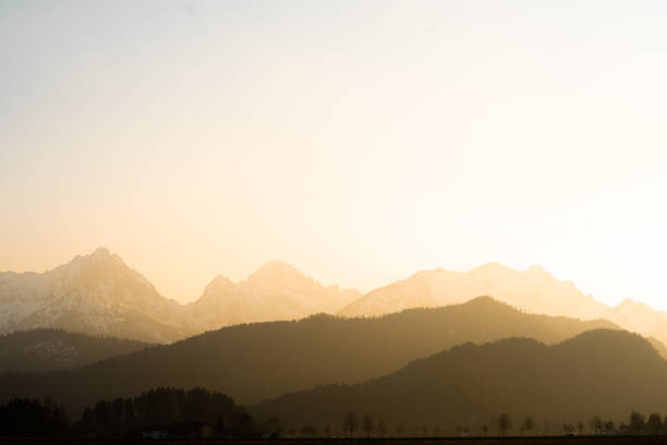 Foggy mountains as a silhouette at sunset