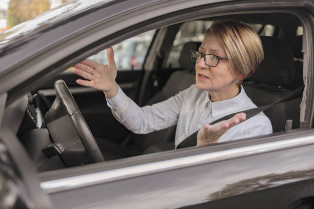 Frustrated mature woman in business car stock photo