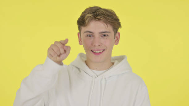 istock Young Man Pointing at Camera, Inviting on Yellow Background 1363991830