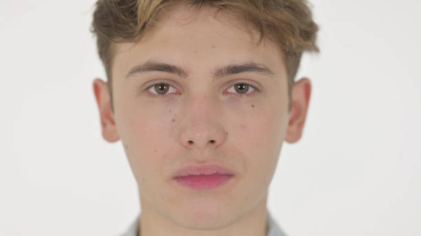 istock Serious Face of Young Man on White Background 1363992988