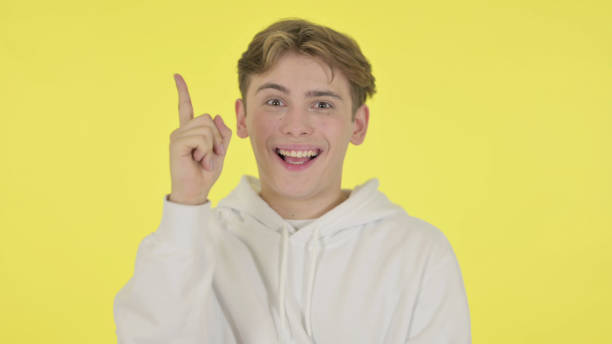istock Thinking Young Man Getting New Idea on Yellow Background 1363993039