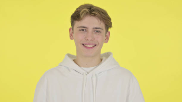 istock Young Man Shaking Head as Yes Sign on Yellow Background 1363993302