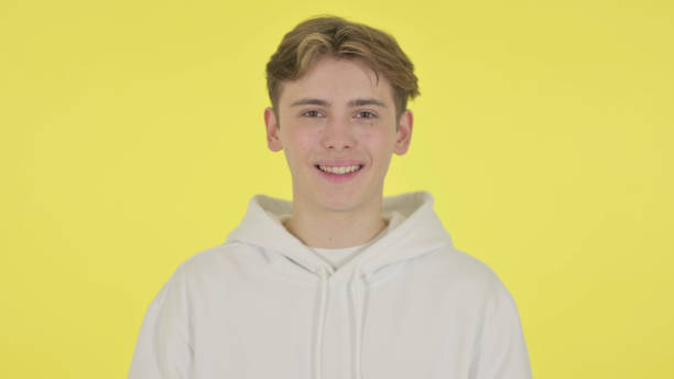 istock Young Man Smiling at Camera on Yellow Background 1363993405