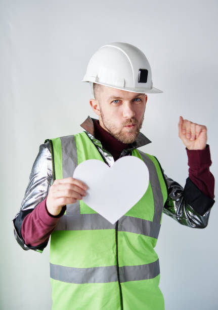 istock Dancing male construction worker with white paper heart 1363994069