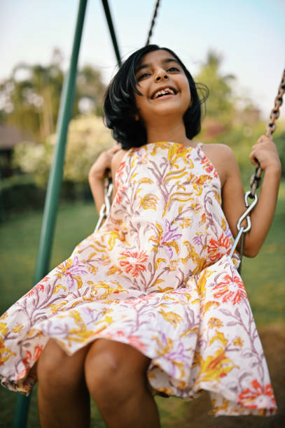 istock Girl playing on the swing 1363995992