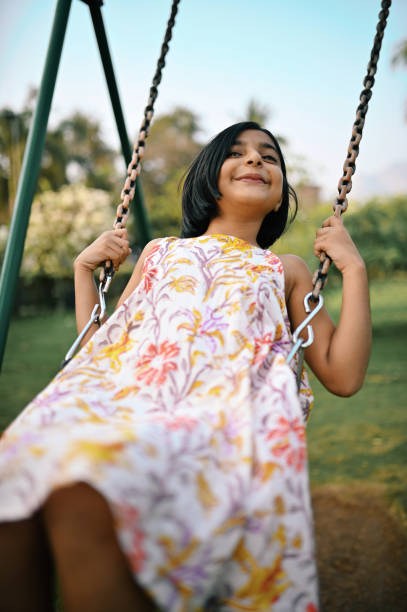 istock Girl playing on the swing 1363995995