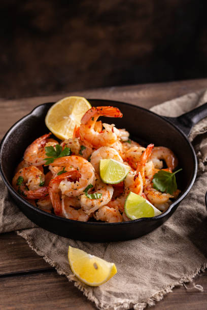 istock Grilled shrimps with greens and garlic in a pan 1363997043