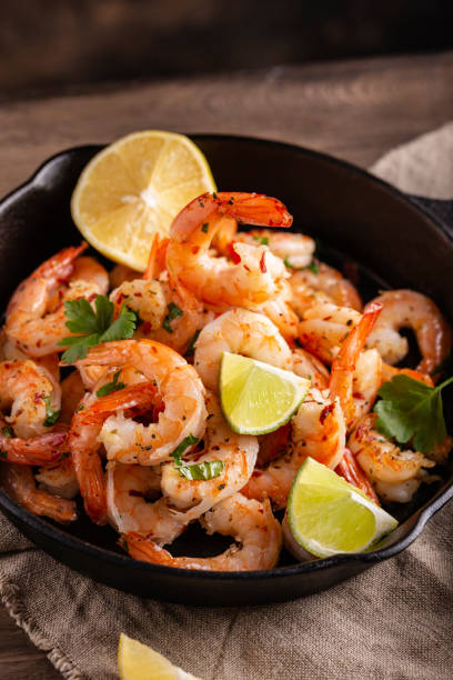 istock Grilled shrimps with greens and garlic in a pan 1363997519