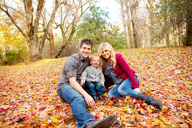 istock Young Family in Fall Leaves 136399941
