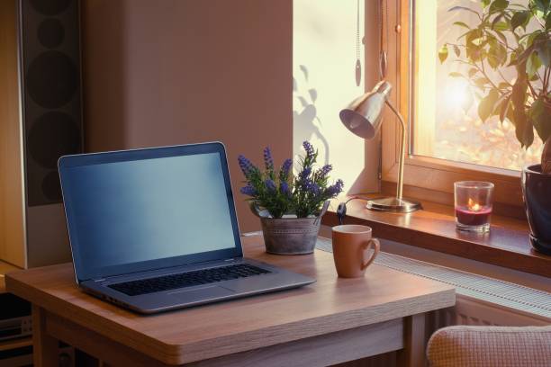 istock Home working place with laptop. Cozy home interior in the warm window light. 1364000363