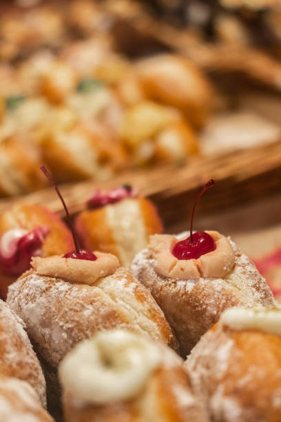 istock Sweet donuts decorated with a cherry. Blurred foreground, side view. Blur and selective focus 1364002125