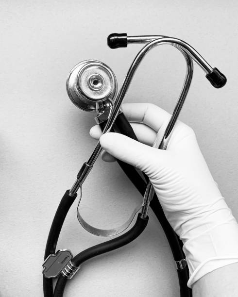 istock phonendoscope in hand close-up, black and white photo 1364002447