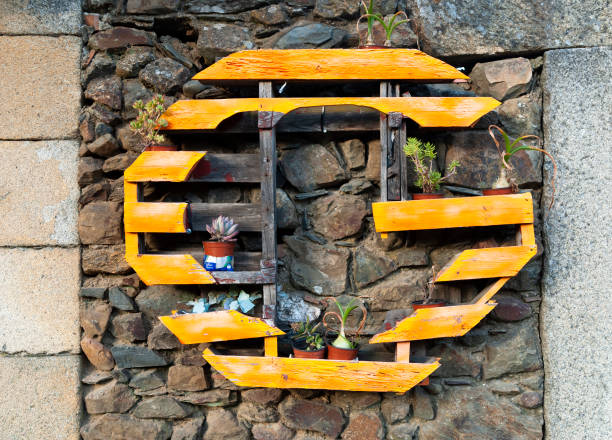 recycling idea industrial pallet as planter with plants on rustic stone wall 2