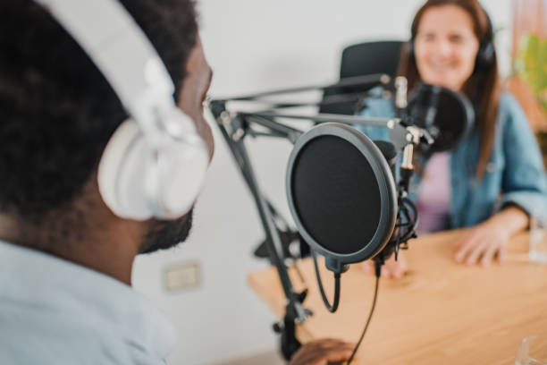 istock black man recording podcast with Woman 1364006159