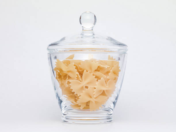 istock Pasta in glass jar on a white background 1364007847