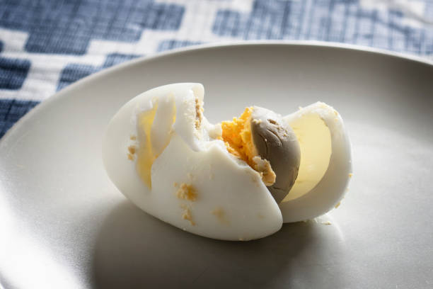 istock Overcooked Hard Boiled Egg with green or grey tint around the yolk. 1364007866