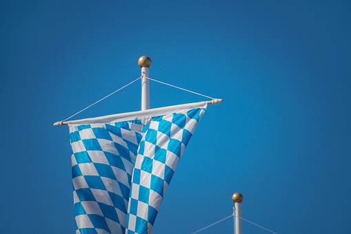 bavarian national flag against blue sky Beer Fest, Munich, Germany